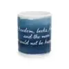 The Inspirational Ceramic Mug features a blue background with white cursive text: freedom, books, flowers & moon. Perfect gift for book lovers, coffee enthusiasts, or home decor.