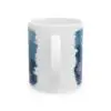 A white ceramic mug with a handle, featuring a partial blue painted design and pastel flowers. The visible text: Inspirational Ceramic Mug - Freedom, Books, Flowers & Moon makes it a perfect gift for book lovers and coffee enthusiasts.